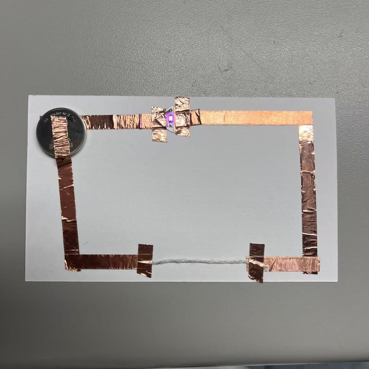 Use the wool to complete the circuit by energizing it.