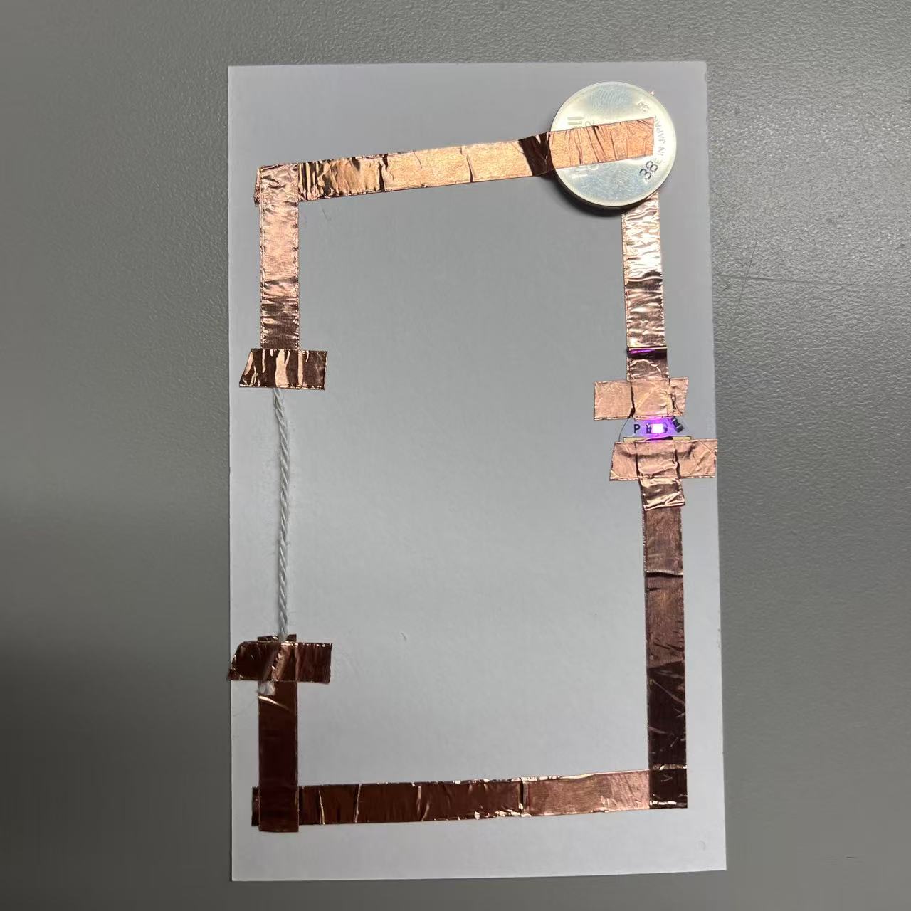 Use the wool to complete the circuit by energizing it.