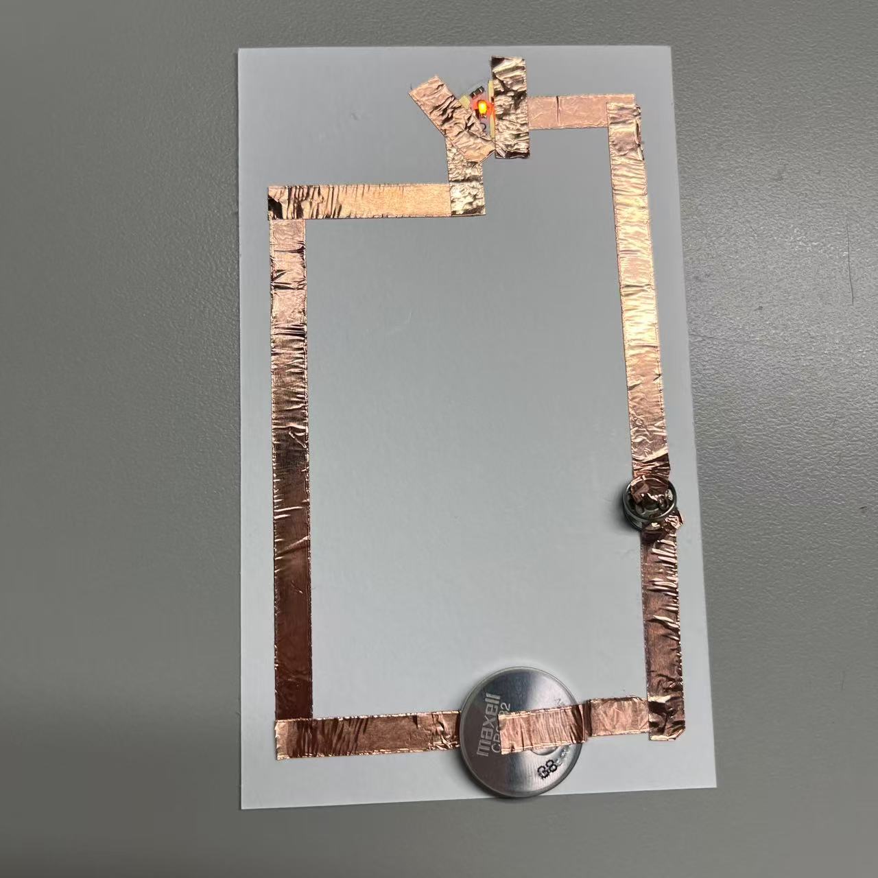 Circuits completed using metal buttons.