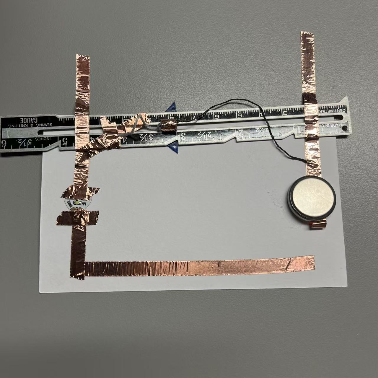 Using wool and a sliding iron ruler, allow the circuit to complete energization.