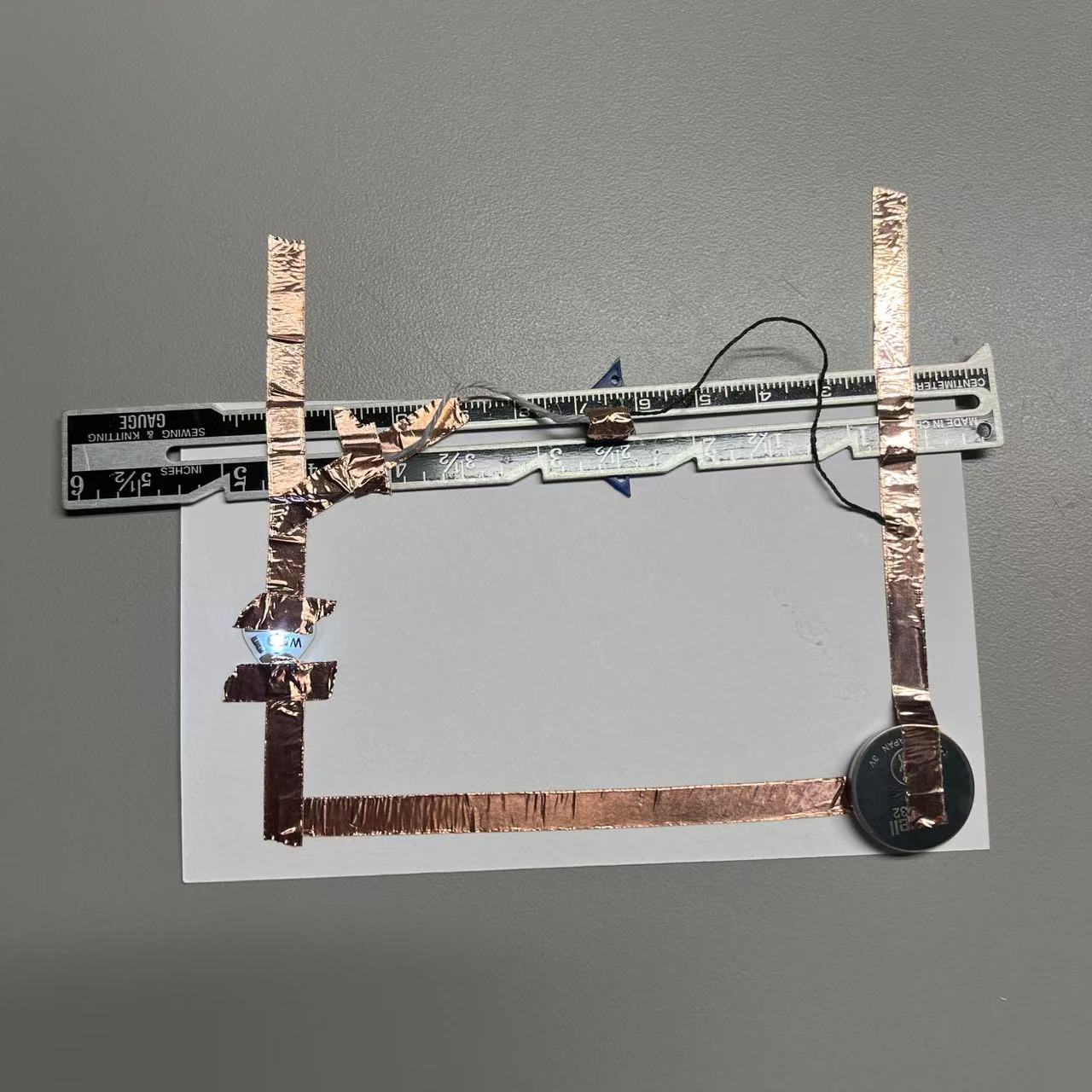 Using wool and a sliding iron ruler, allow the circuit to complete energization.