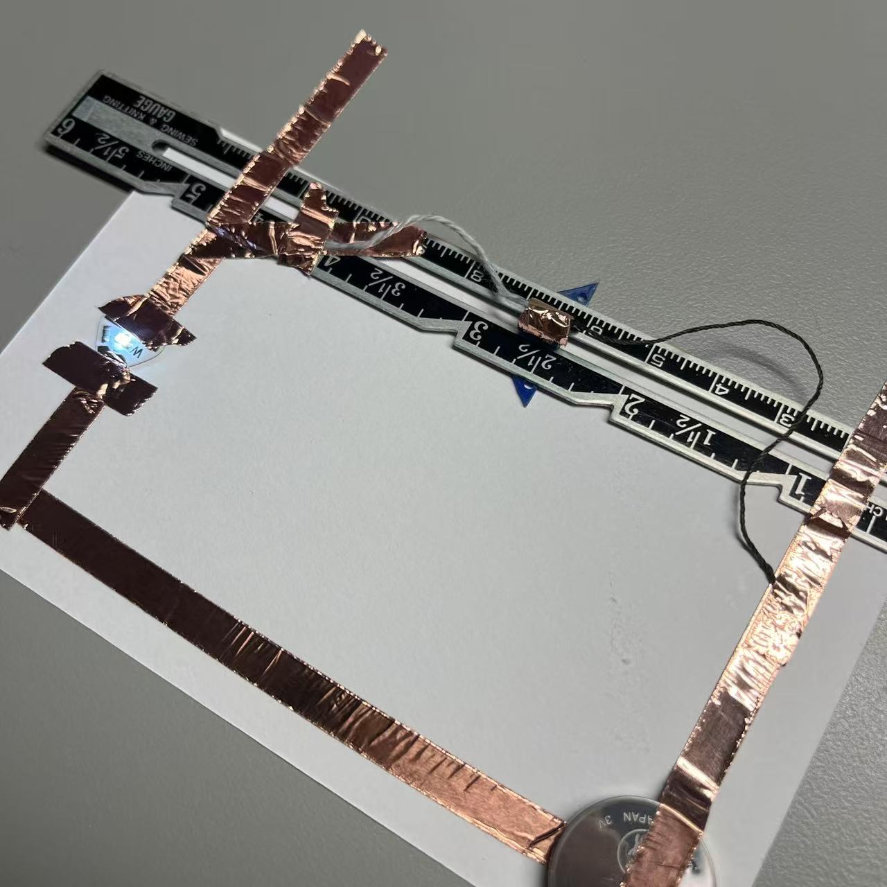 Using wool and a sliding iron ruler, allow the circuit to complete energization.