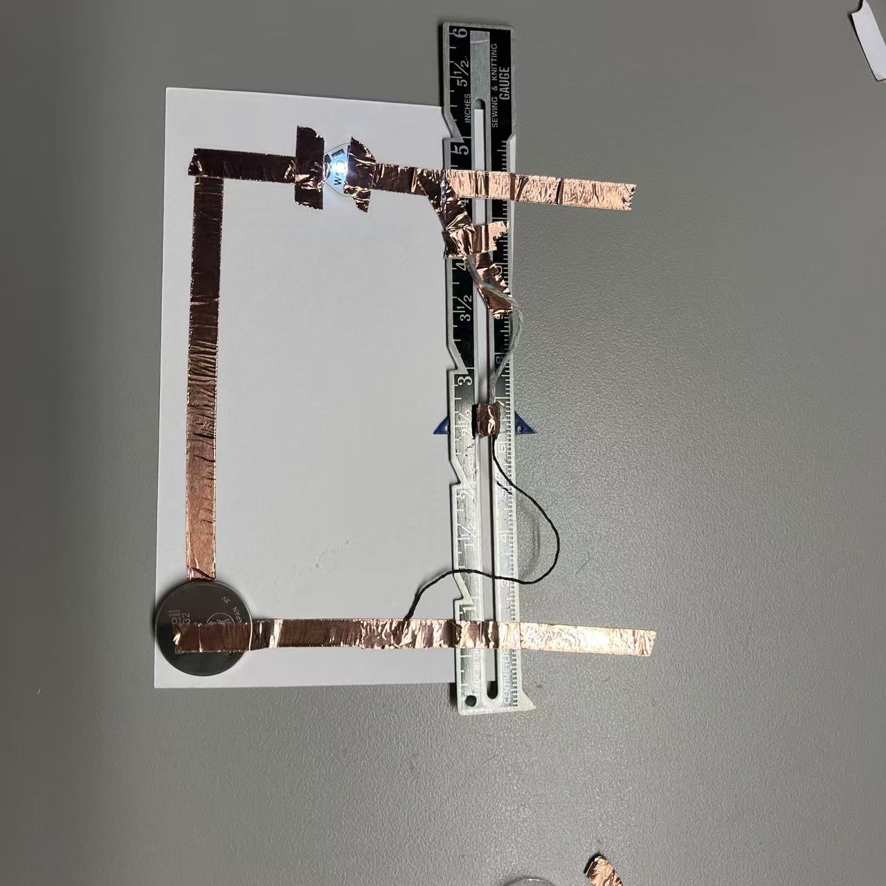 Using wool and a sliding iron ruler, allow the circuit to complete energization.