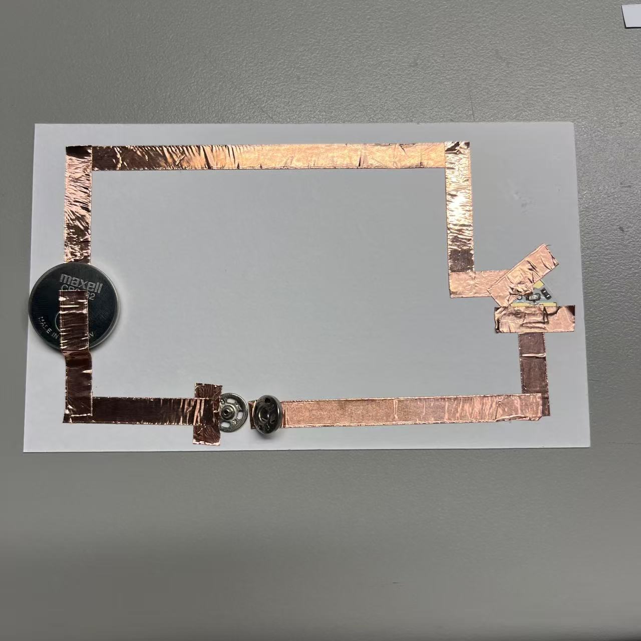 Circuits completed using metal buttons.